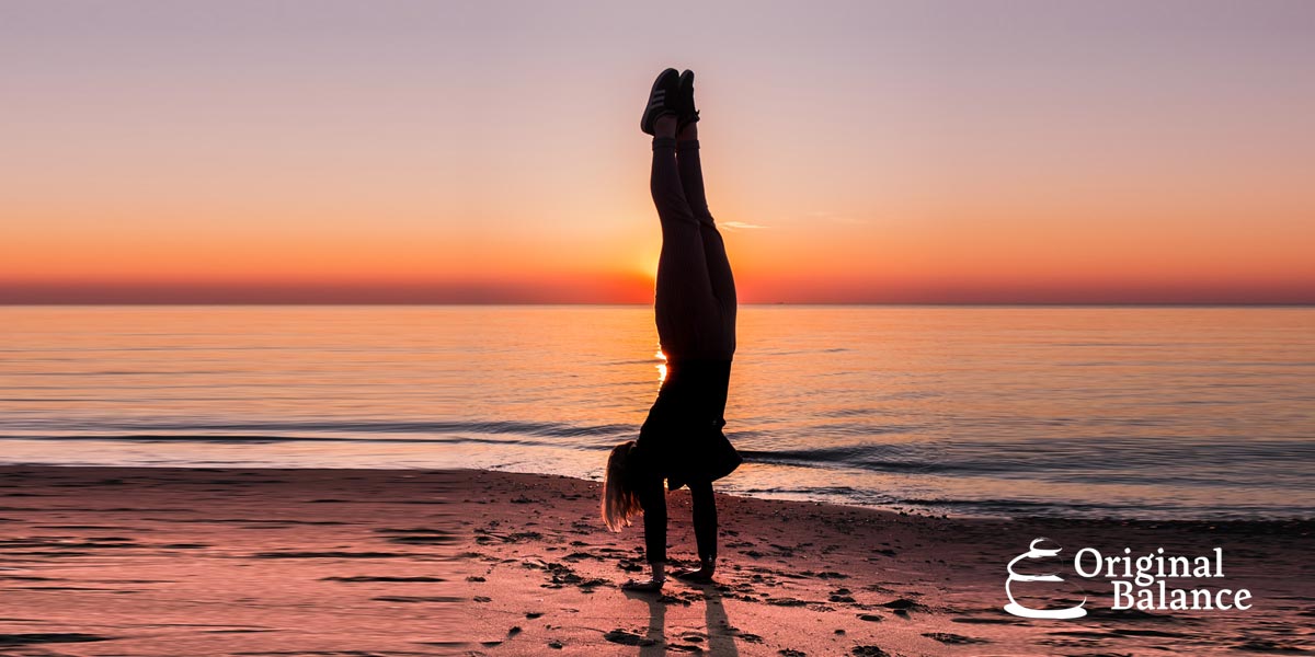 Original-Balance-Getting-the-High-Performance-Mastery-photo-of-a-woman-balancing-her-self-upside-down